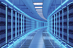 View down the corridor of a large, brightly-lit data center.