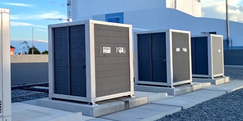 Line of rooftop HVAC units on top of building.